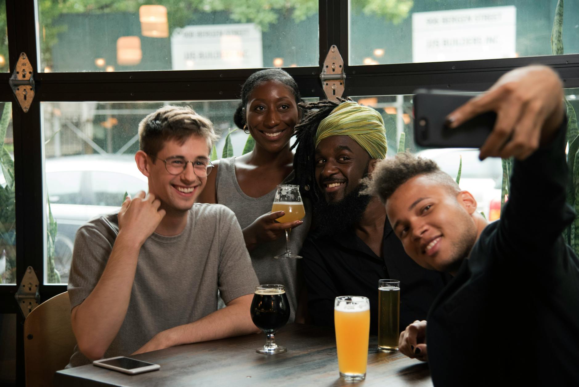 Happy Multiethnic Friends Taking Selfie On Smartphone In Cafe