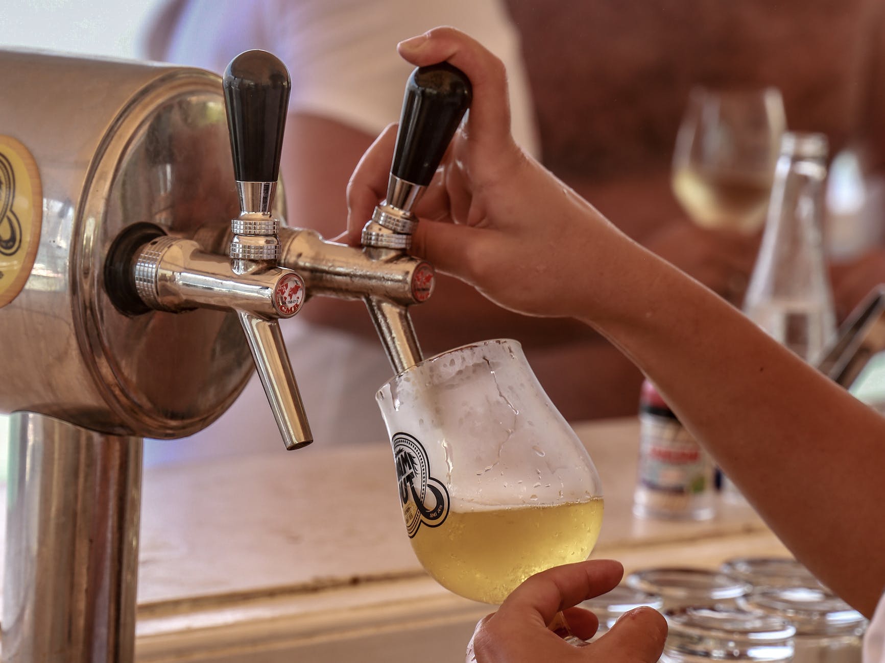 A Person Getting Beer From A Beer Tap