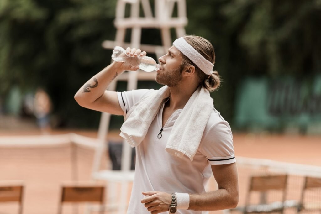 A Man Drinking Water From A Bottle