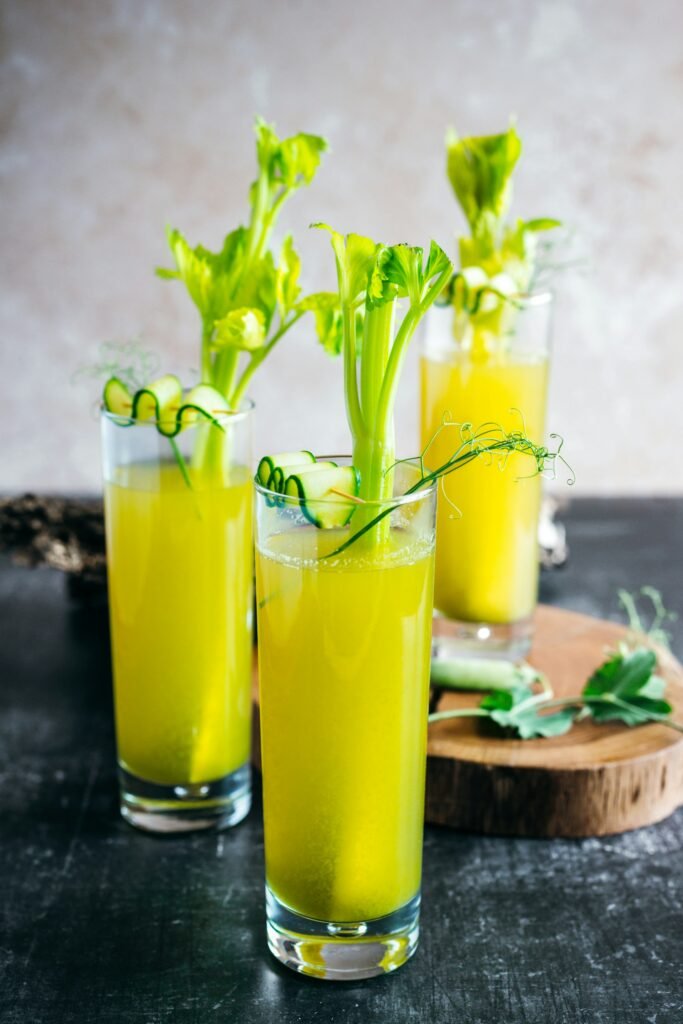 A Group Of Glasses With Liquid And Green Liquid