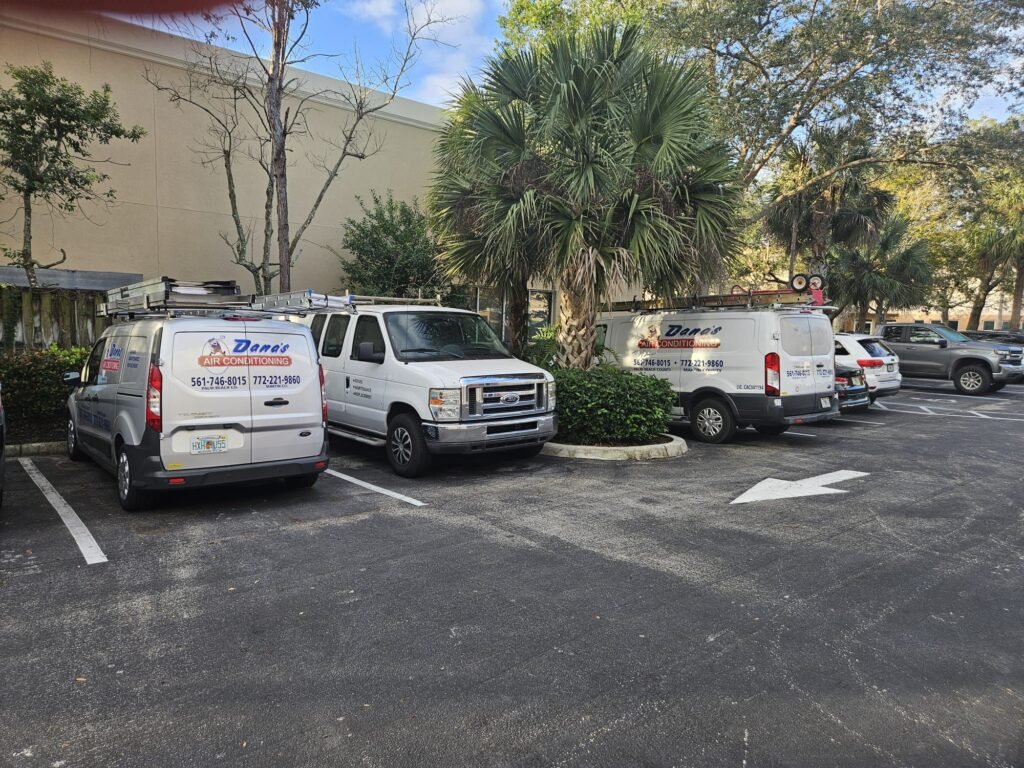 A Group Of Vans Parked In A Parking Lot Air Conditioning Installation West Palm Beach